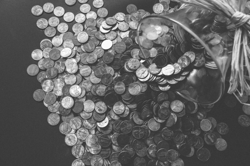 Jar of pennies tipped on a table